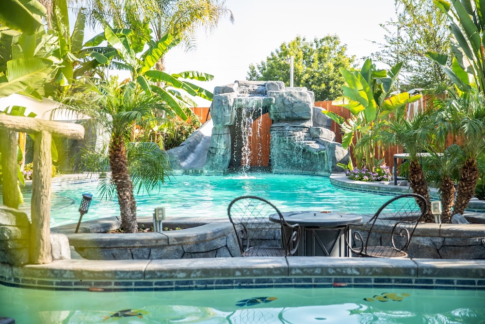 Resort-style lagoon pool with a rock waterfall