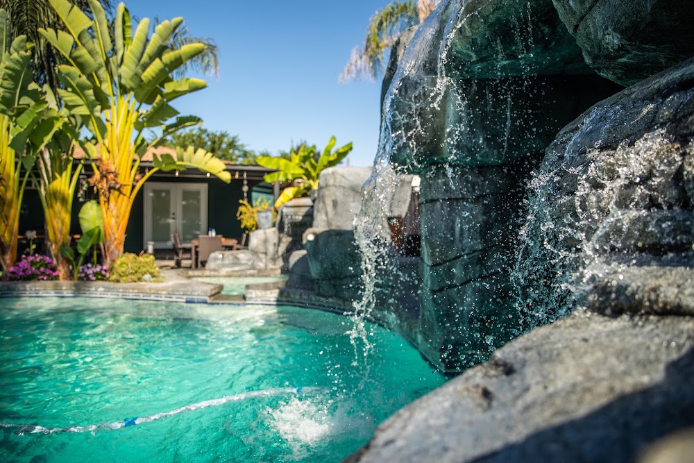 Lagoon pool with a bridge and tropical planting